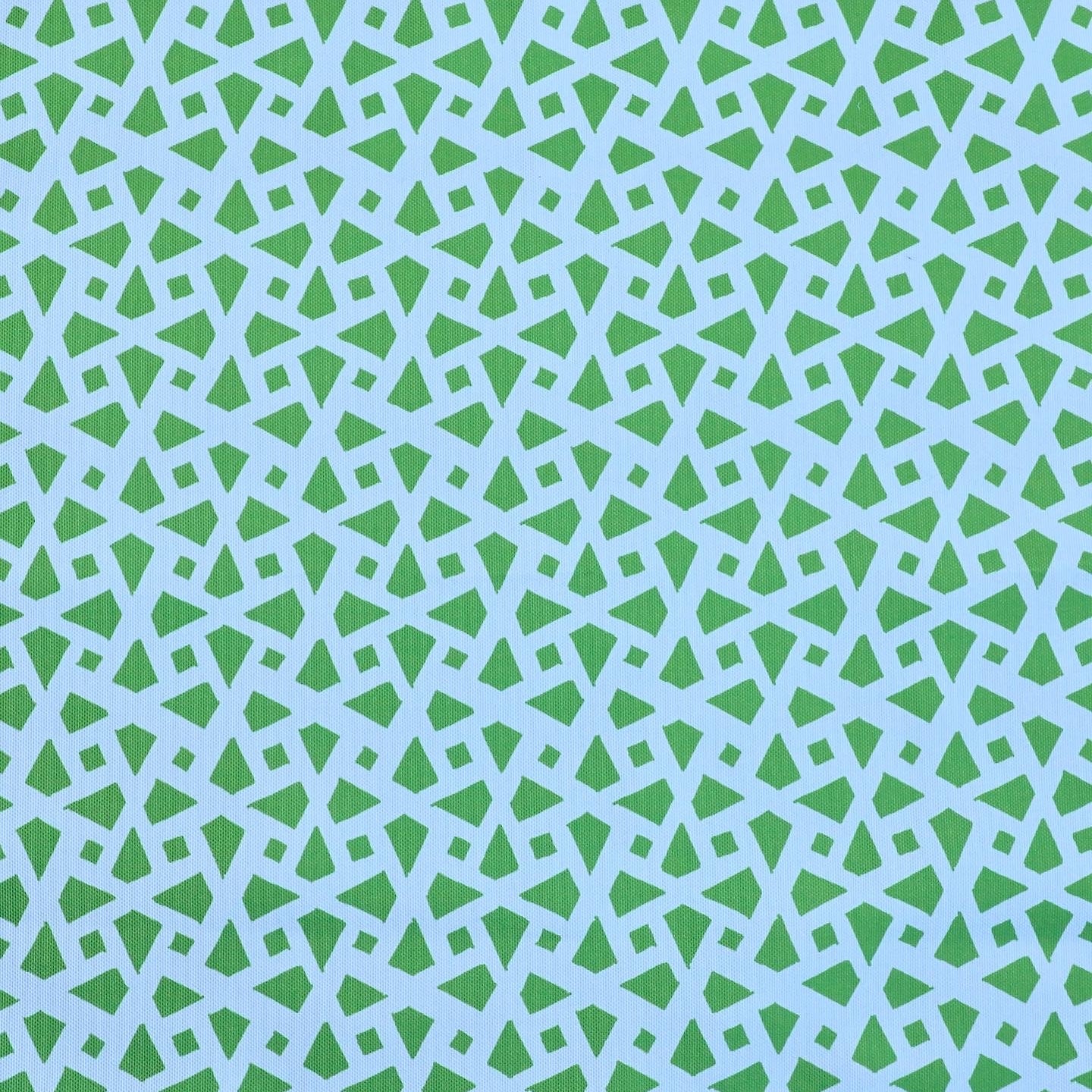 Detail of fabric in a geometric lattice print in green on a light blue field.