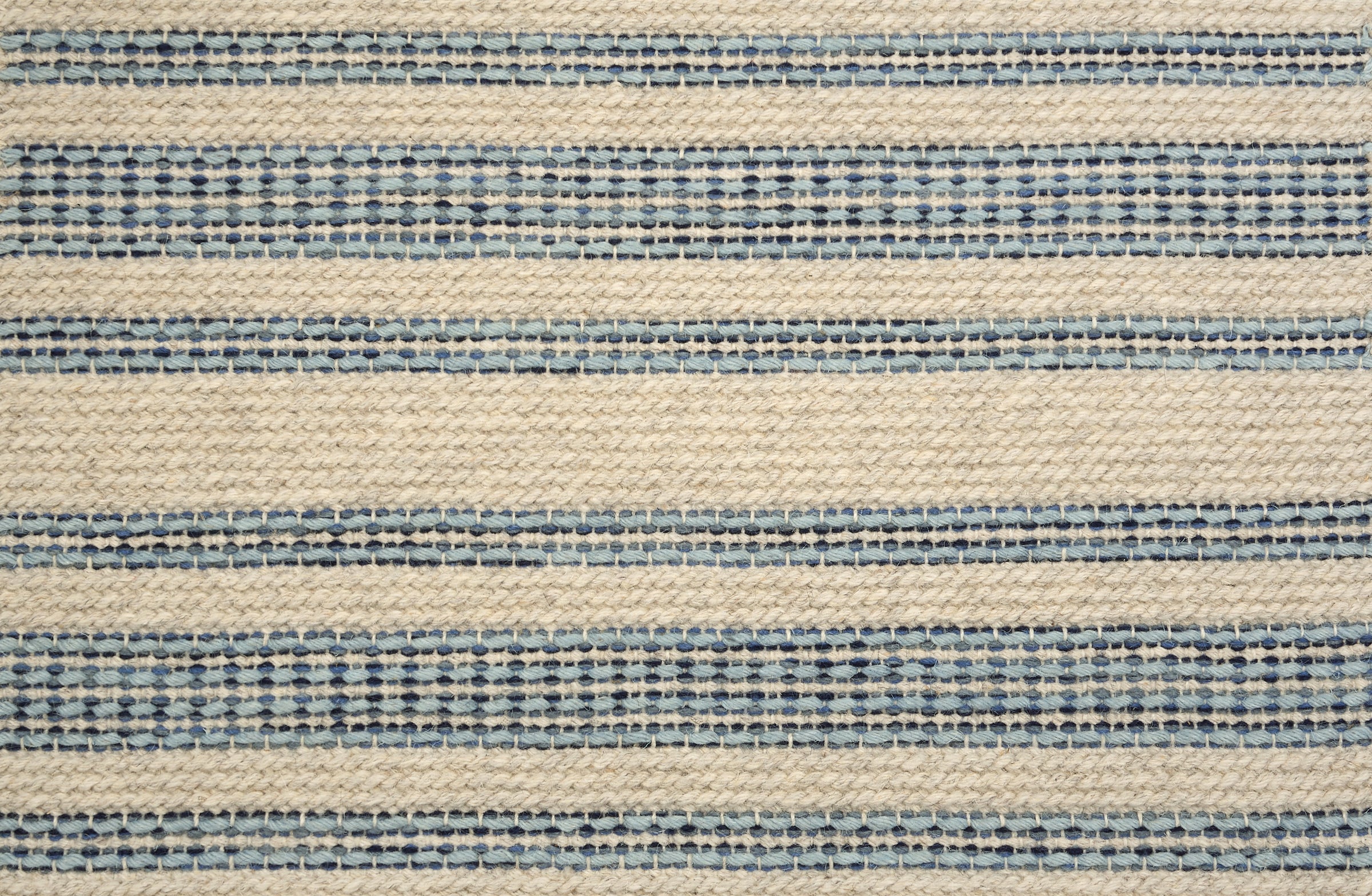 Broadloom carpet in cream with blue stripes.