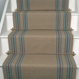 Striped flatweave runner in tan blue and red on white staircase