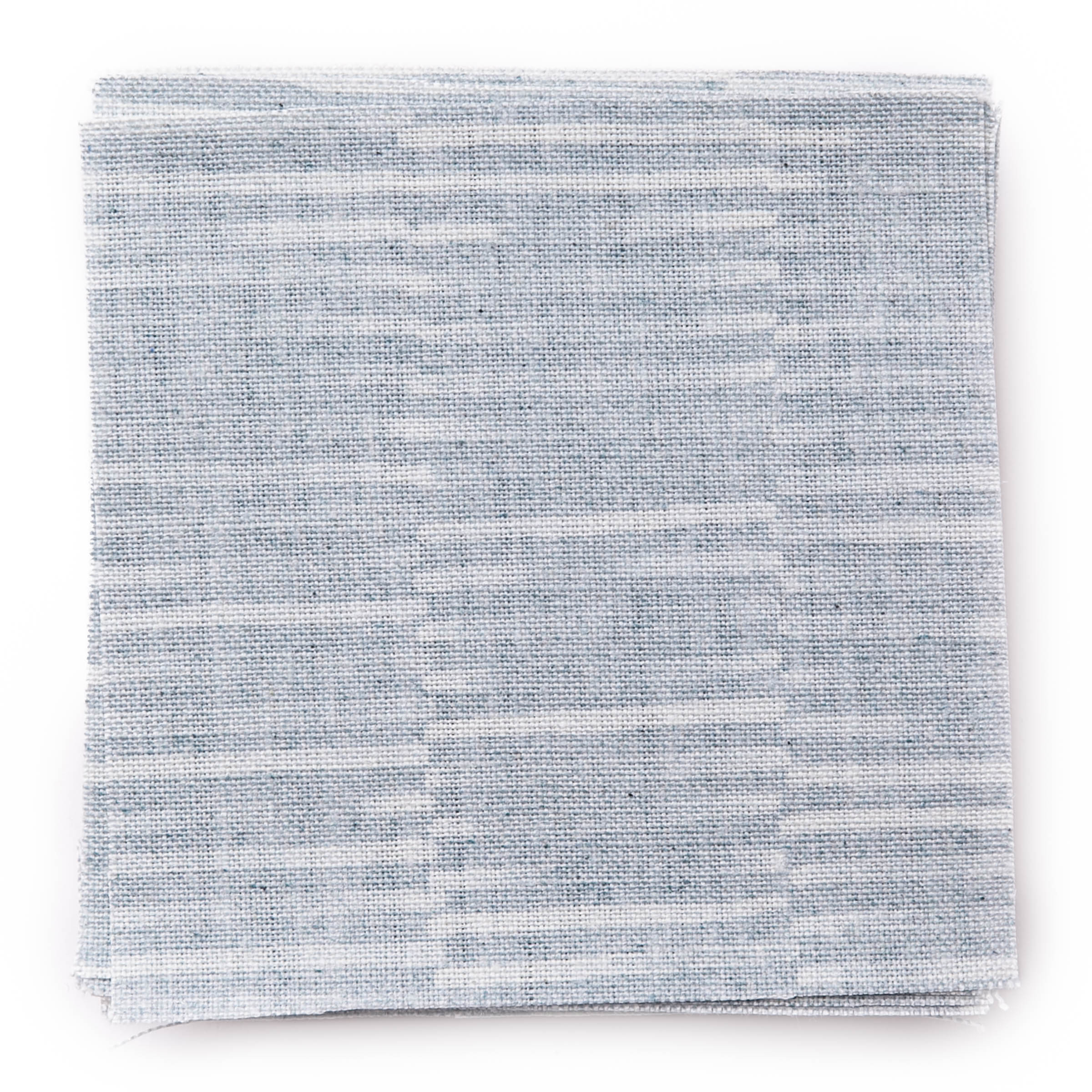 A stack of fabric swatches in a small-scale checked pattern in shades of light blue.