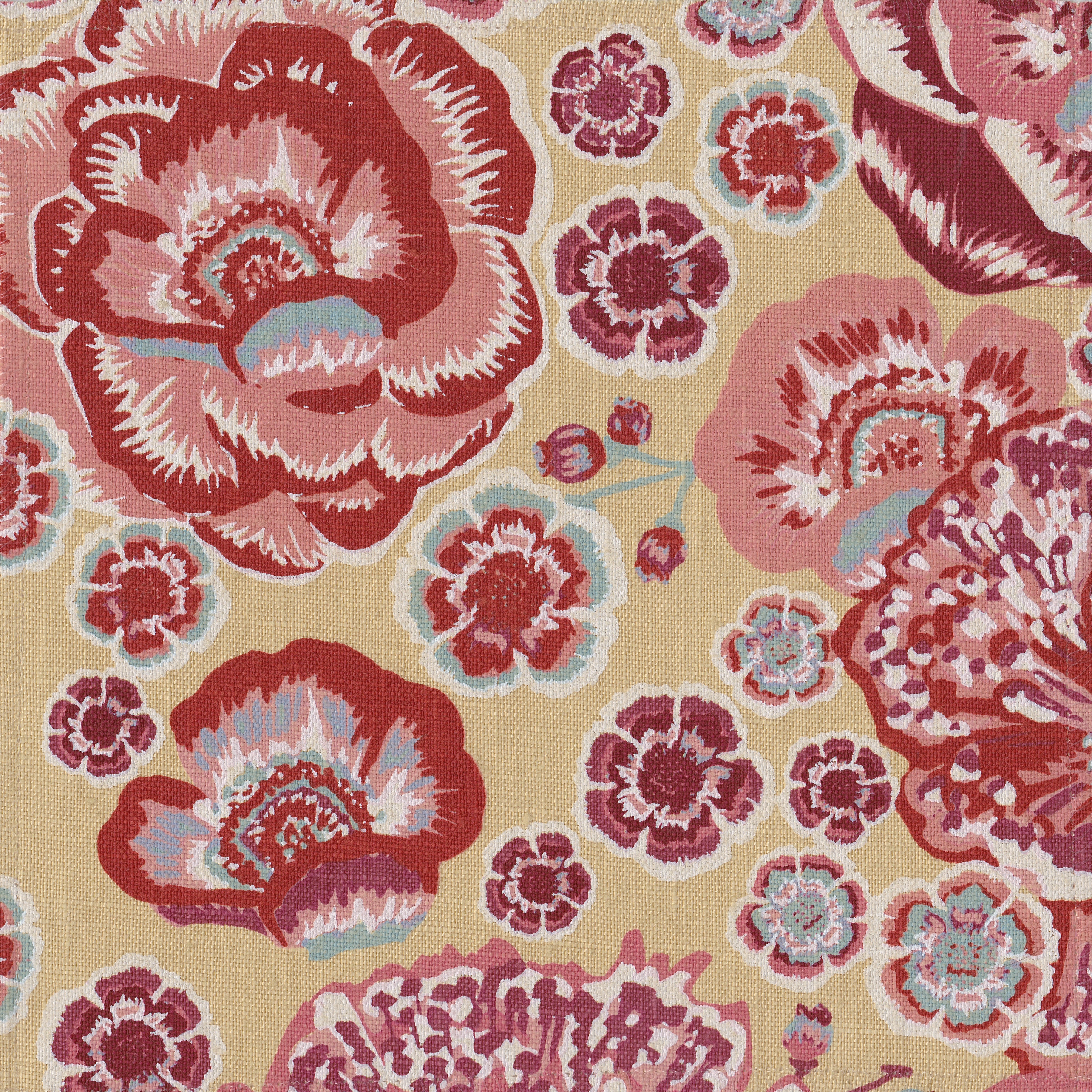 Detail of fabric in a floral print in shades of pink, red and blue on a tan field.