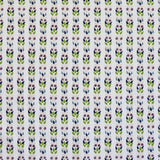 Detail of fabric in a striped botanical print in shades of blue, purple and green on a cream field.