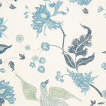 Detail of wallpaper in a bird and botanical print in shades of blue and green on a cream field.