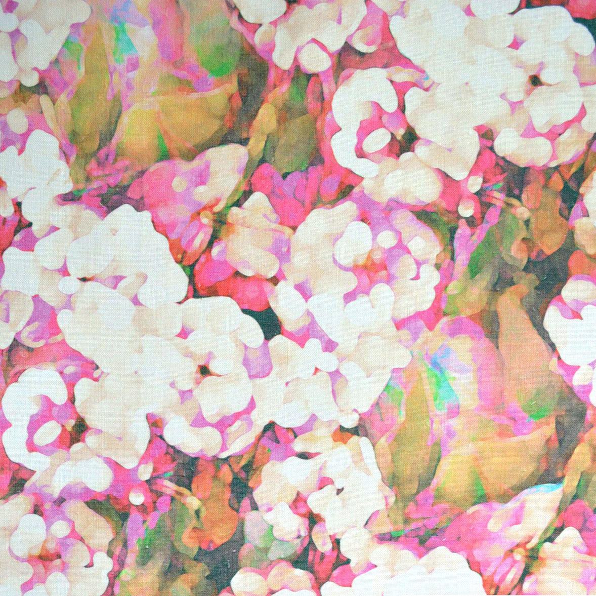Detail of fabric in an abstract floral print in technicolor shades of pink, cream and green.