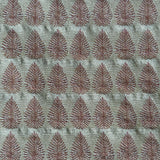 Detail of fabric woven in a repeating leaf print in shades of purple and turquoise.