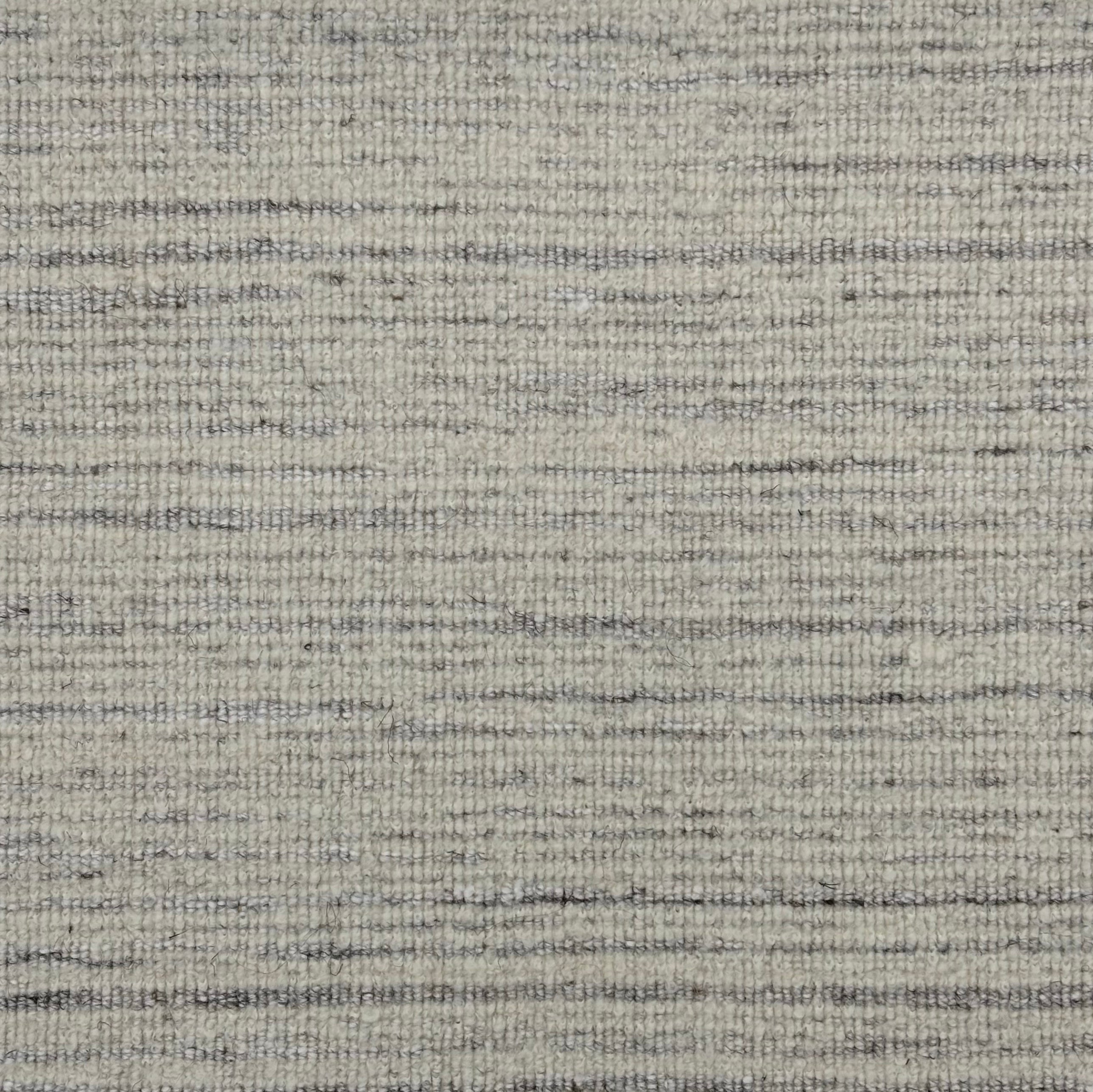 Handknotted rug sample in a textural blend of soft heathered grey and white. 