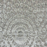 Handknotted wool rug in a raised circular compass design in shades of grey. 