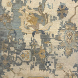 Handknotted carpet in an old word damask floral in shades of muted blue, cream and tan. 