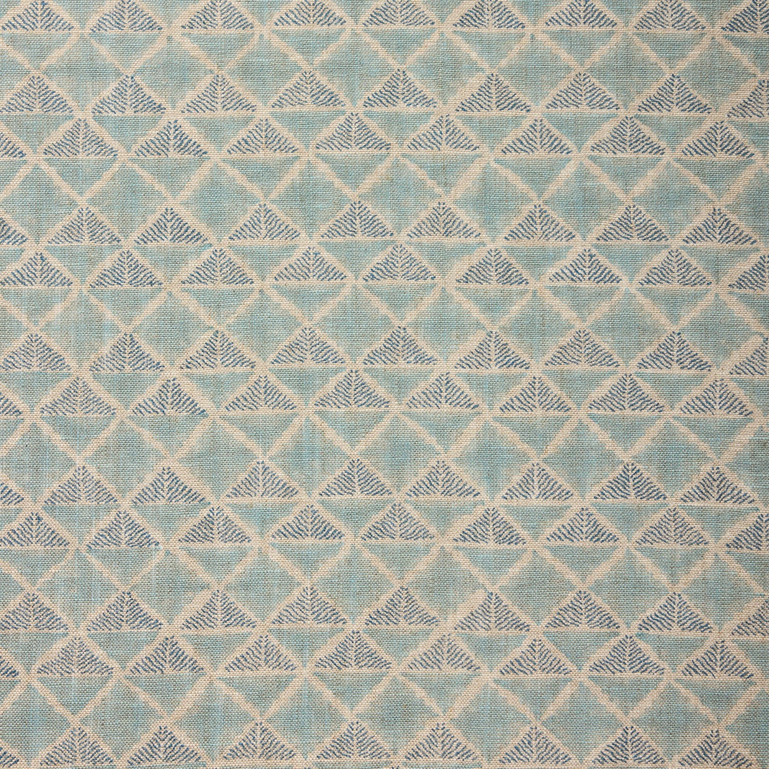 Textile pattern with geometric design in shades of blue.
