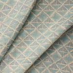 Textile with a geometric pattern of triangles in shades of blue.