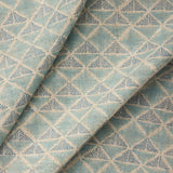 Textile with a geometric pattern of triangles in shades of blue.