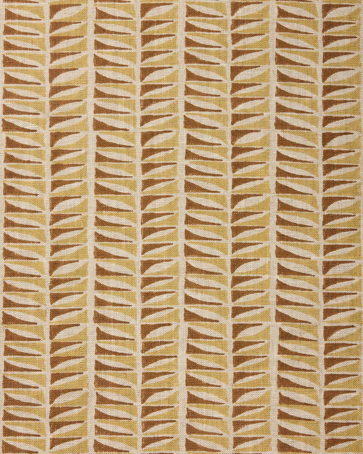Close-up of fabric with a geometric leaf pattern in brown and beige.