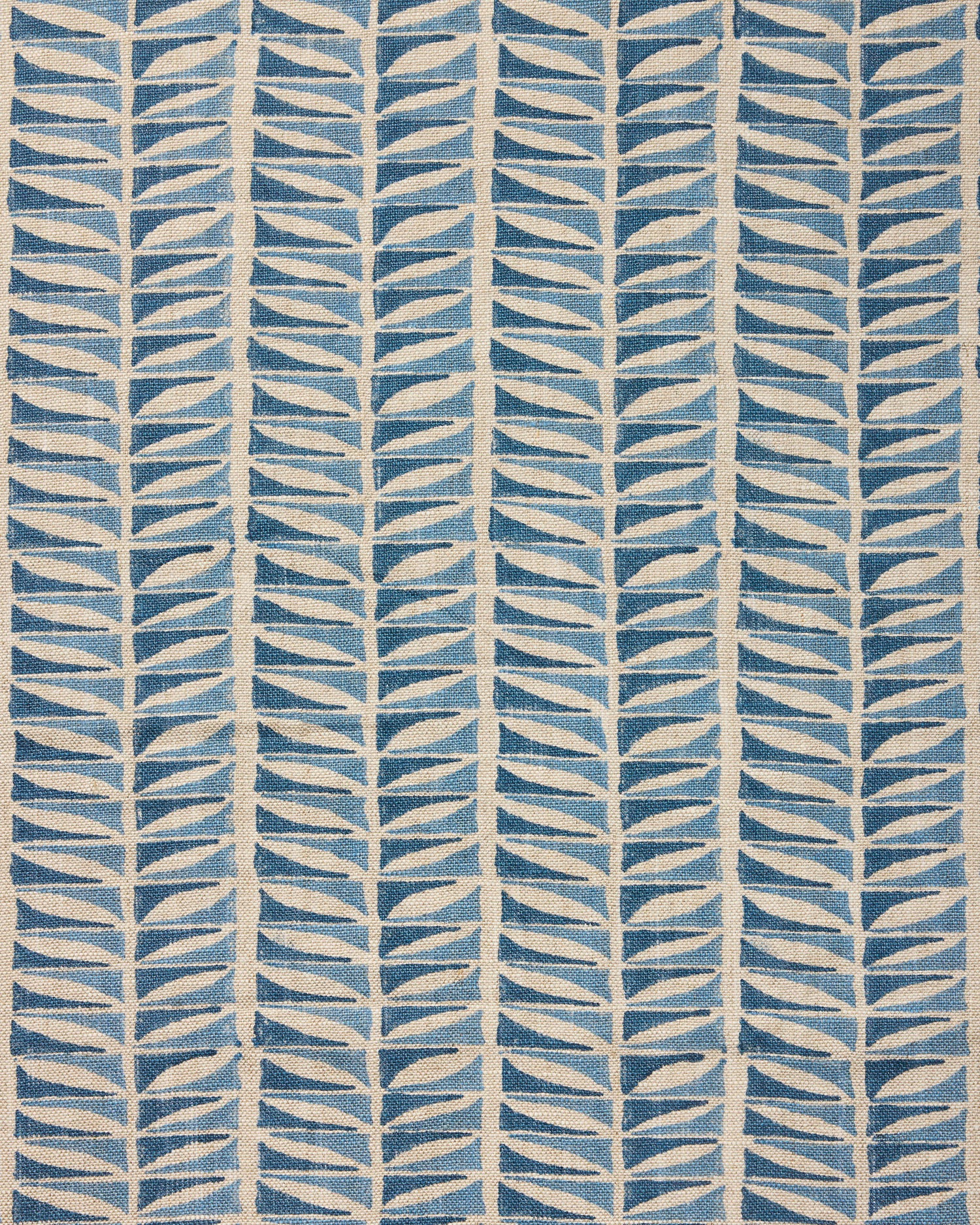 Close-up of fabric with a geometric leaf pattern in blue.