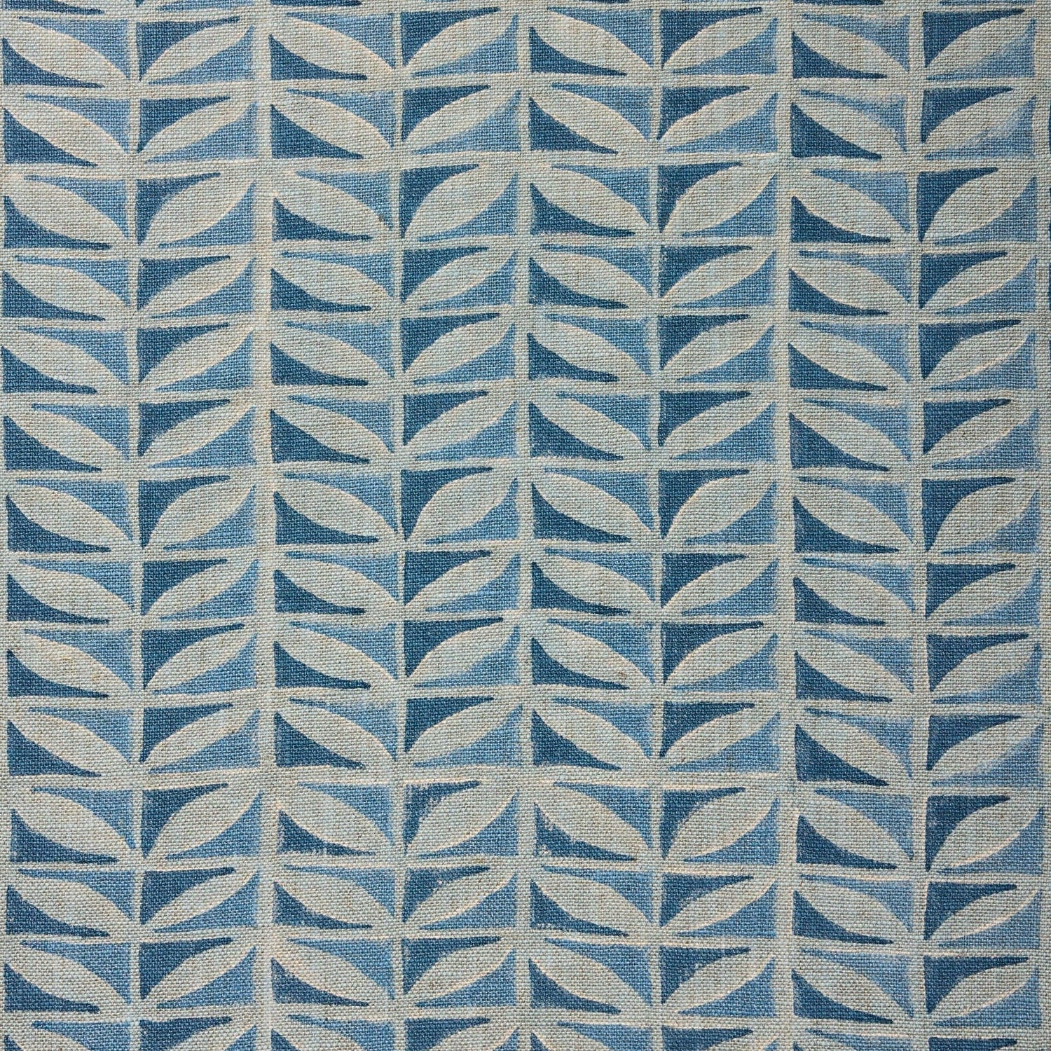 Close-up of fabric with a leaf pattern in shades of blue.