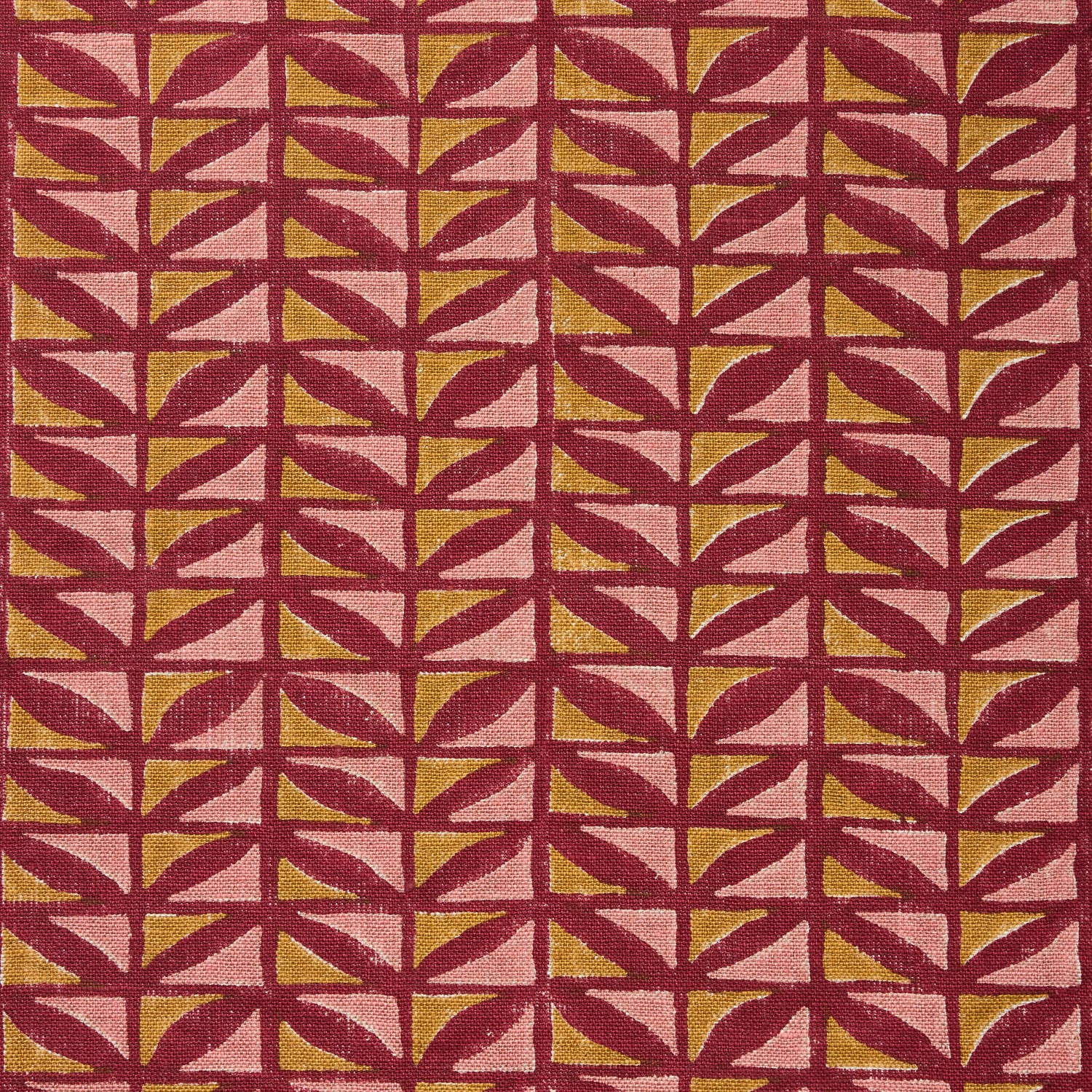 Close-up of fabric with geometric pattern in pink and ochre on a crimson field. 
