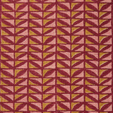 Close-up of fabric with geometric pattern in pink and ochre on a crimson field. 