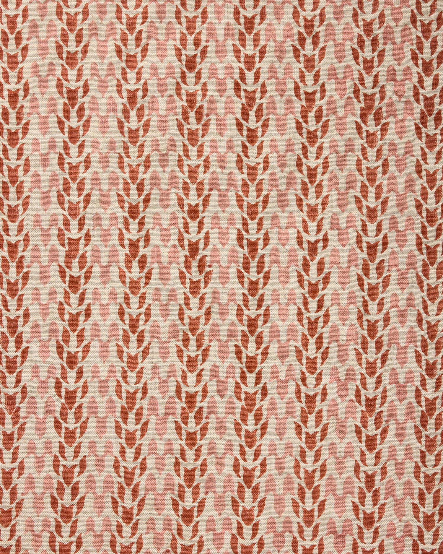 Fabric with a abstract leaf pattern in red and pink on a neutral background