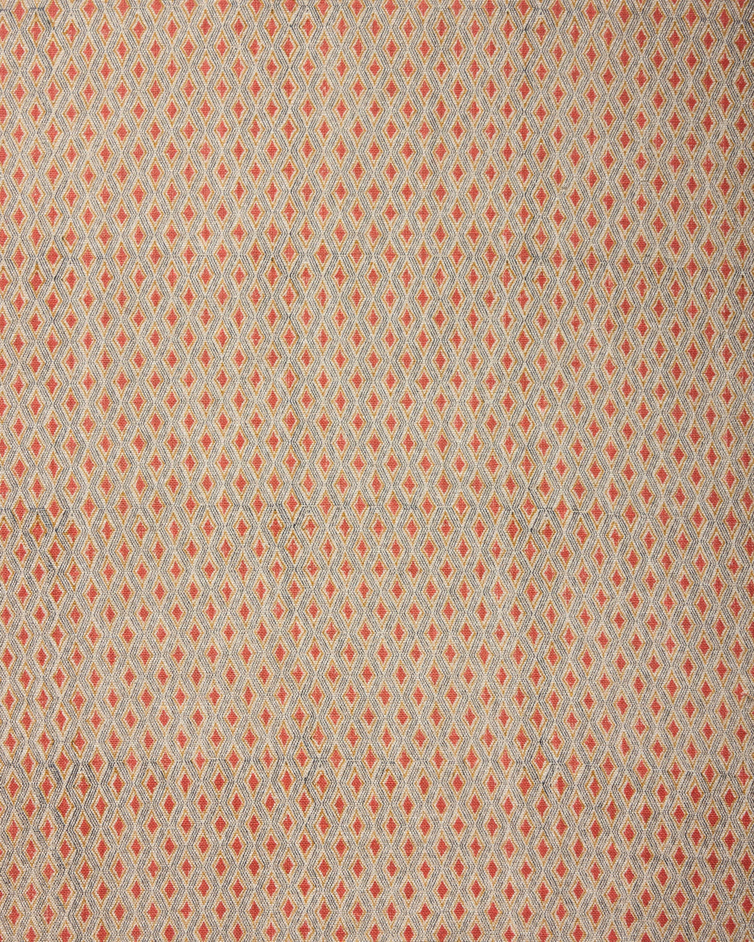 Textile pattern with small diamond shapes in red on a beige background