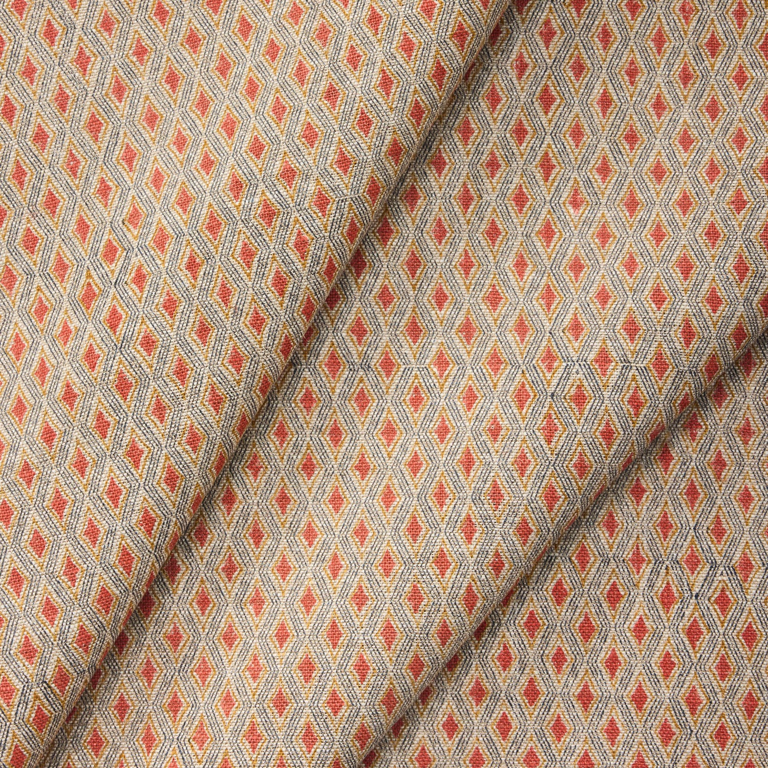Draped fabric with a diamond pattern in red and beige. 