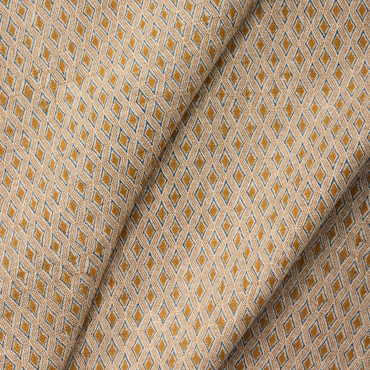 Draped fabric with a geometric pattern in beige and brown tones.