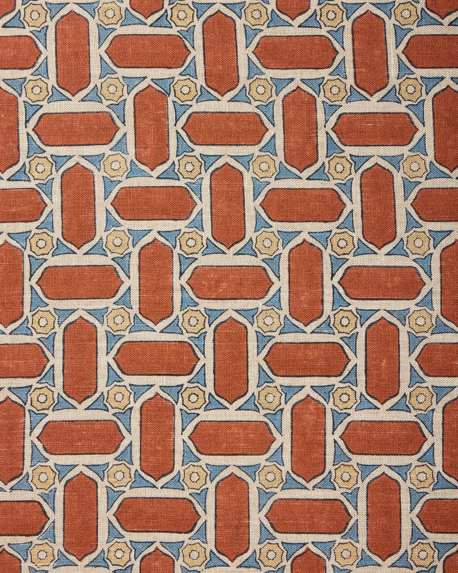 Fabric with geometric mosaic pattern of red, blue, and beige colors.