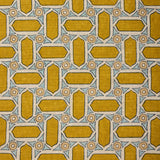 Close-up of fabric with geometric mosaic pattern in yellow and blue