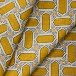 Close-up of draped fabric with geometric mosaic pattern in yellow and blue