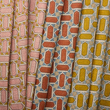 Three fabric swatches with geometric mosaic patterns in pink, red, and yellow.