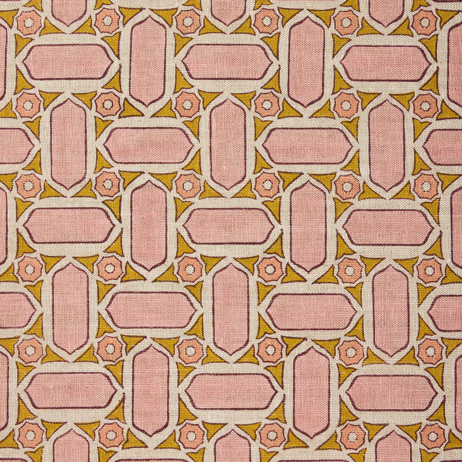 Fabric with geometric mosaic pattern of pink and green.