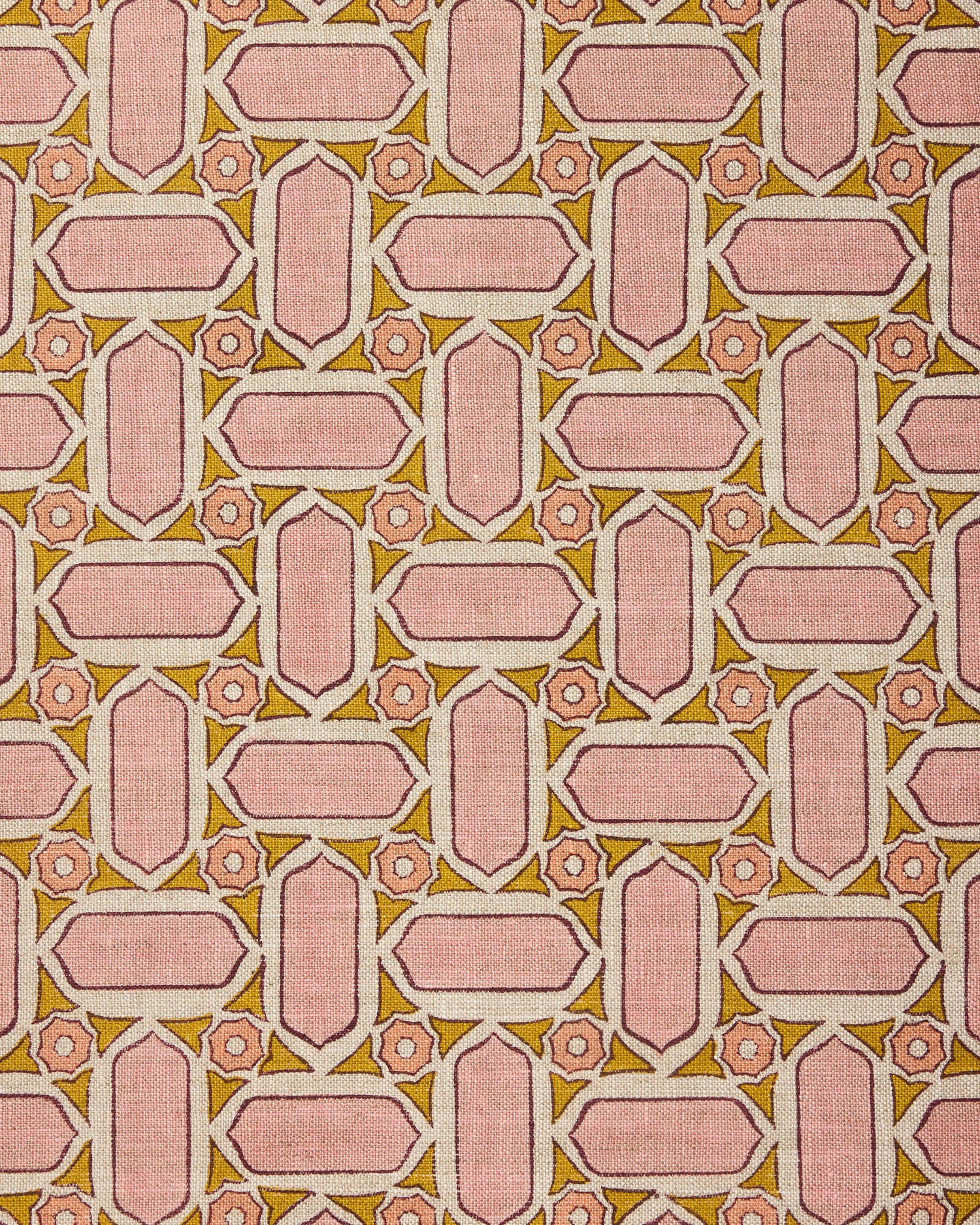 Fabric with geometric mosaic pattern of pink and green.