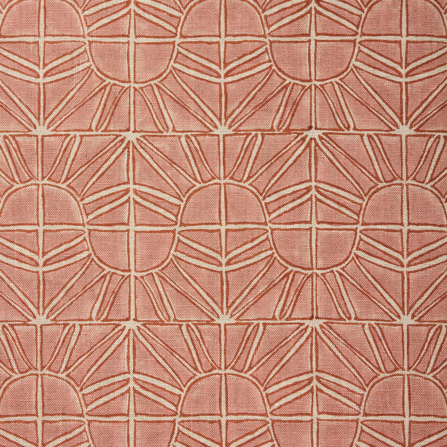 Fabric with geometric sun pattern in clay pink and rust red.