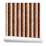 Partially unrolled wallpaper in a curvy hand-painted stripe pattern in shades of brown, gold, rust and white.