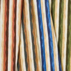 A group of draped woven fabrics, each in a different colorway of a curvy hand-painted stripe pattern.