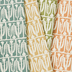 A group of draped woven fabrics, each in a different colorway of an abstract repeating tulip print.