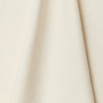 A draped swatch of linen fabric in a solid cream color.