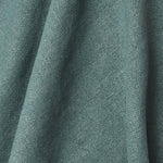 A draped swatch of old-world linen fabric in a solid dark green color.