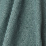 A draped swatch of old-world linen fabric in a solid dark green color.