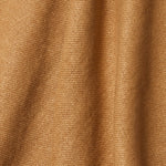 A draped swatch of old-world linen fabric in a solid tan color.