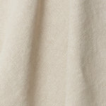 A draped swatch of old-world linen fabric in a solid cream color.