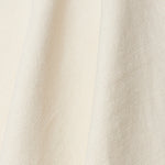 A draped swatch of old-world linen fabric in a solid white color.