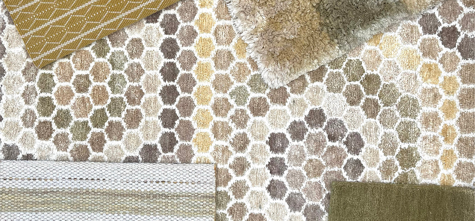 A detail image of custom rug samples in a range of subtle patterns in grey, taupe, ochre and olive.