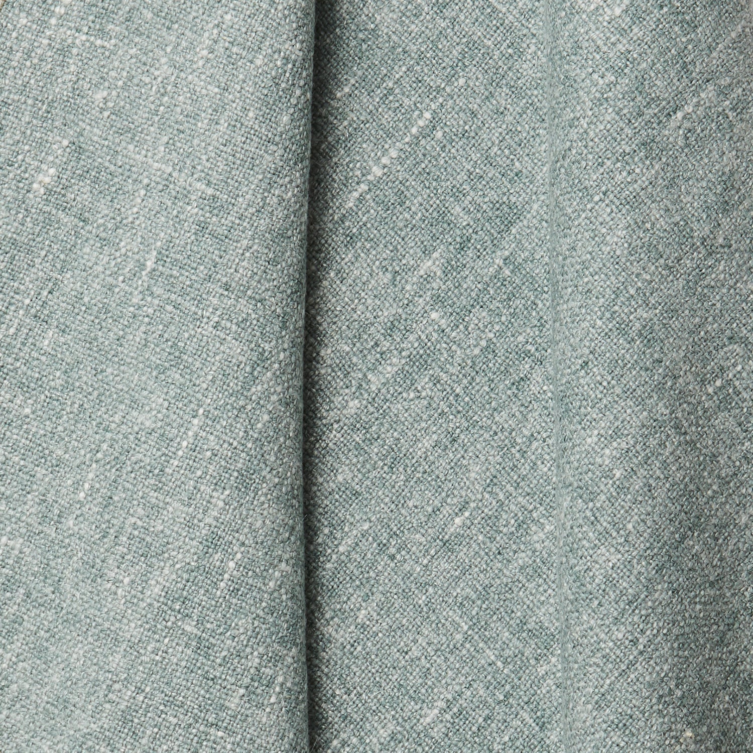 A draped swatch of blended linen fabric in a mottled light jade color.
