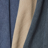 A row of three folded linen swatches in shades of navy and tan.
