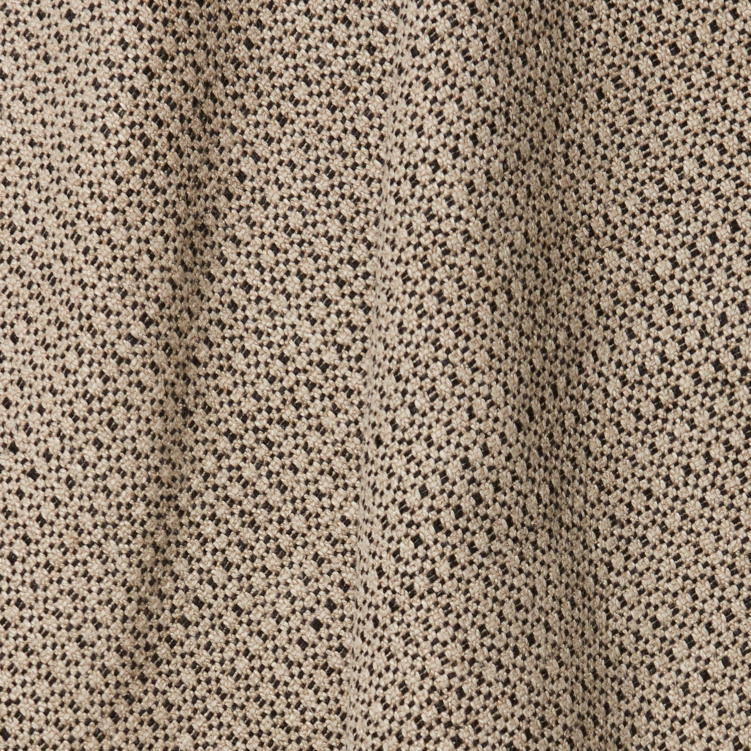 A draped swatch of linen fabric in a small-scale dotted pattern in tan and dark brown.