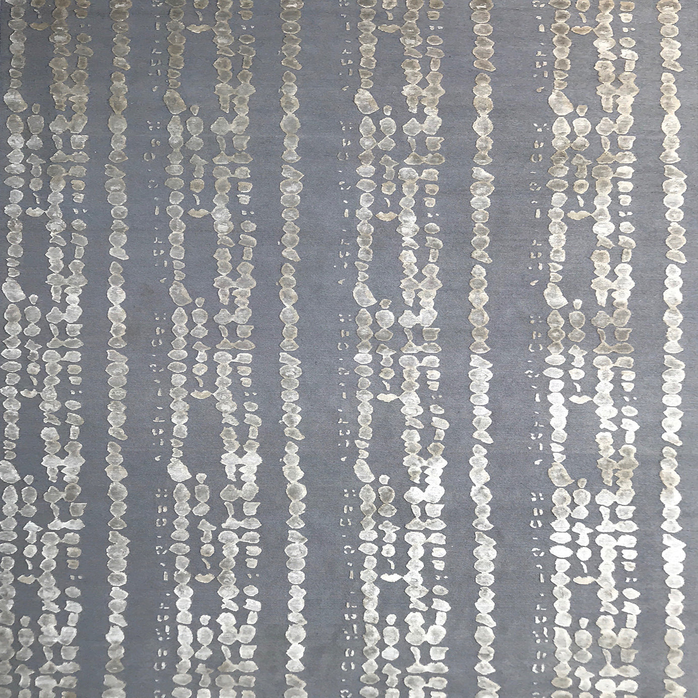 Handknotted rug in a bold painterly design in taupe and grey. 