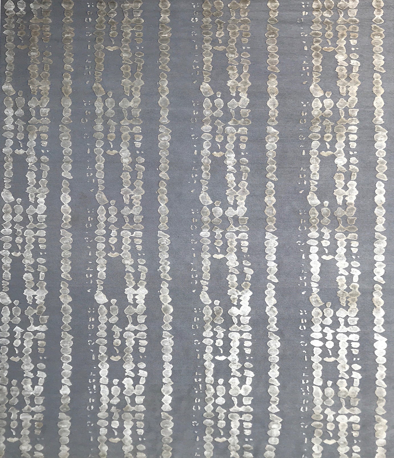 Handknotted rug in a bold painterly design in taupe and grey. 