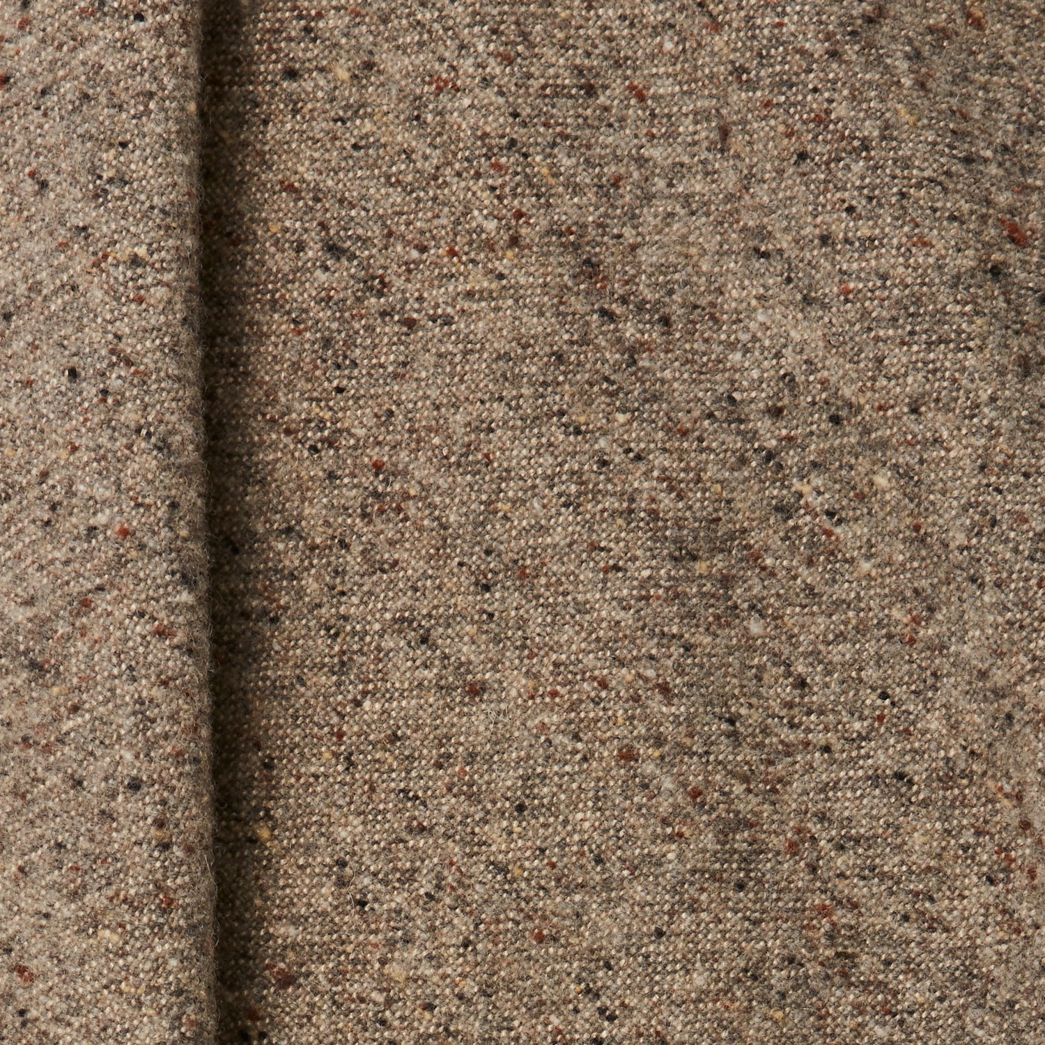 A draped swatch of blended linen-wool mix fabric in a flecked light brown color.