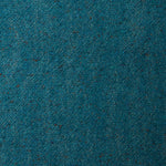 A swatch of blended linen-wool mix fabric in a flecked turquoise color.