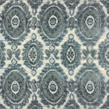 Detail of a handknotted rug with a floral medallion pattern in shades of acqua and grey. 