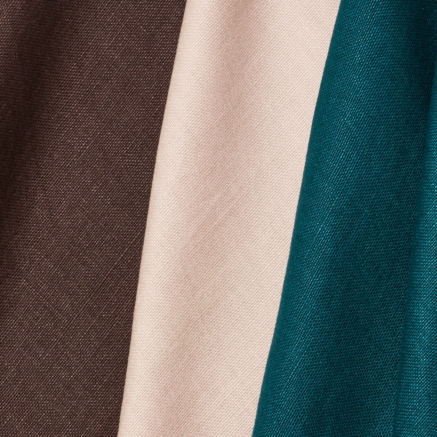 A group of three folded pieces of linen fabric in shades of espresso, turquoise and pale pink.